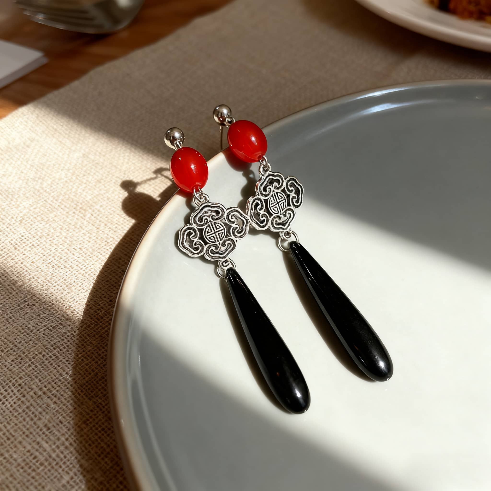 Anger teardrop earrings with red beads and silver cloud charms for a unique style