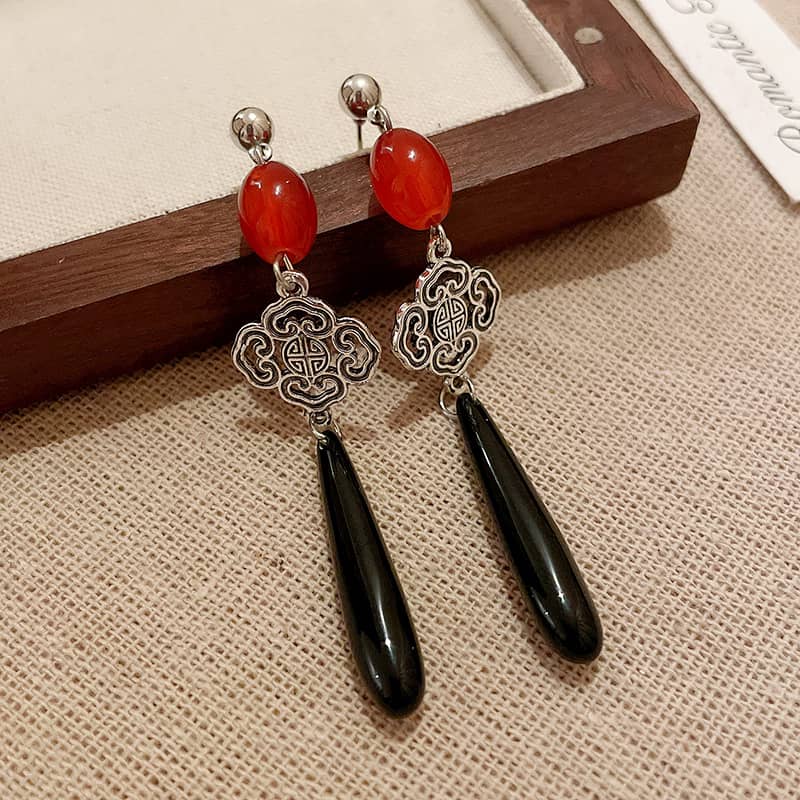 Anger teardrop earrings featuring red beads and black drop accents for a bold statement