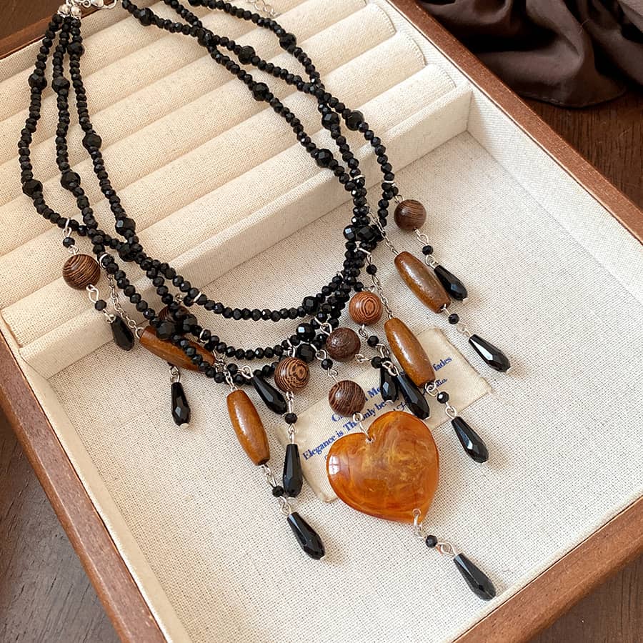 Angry heart resin necklace featuring black and brown beads in a layered design