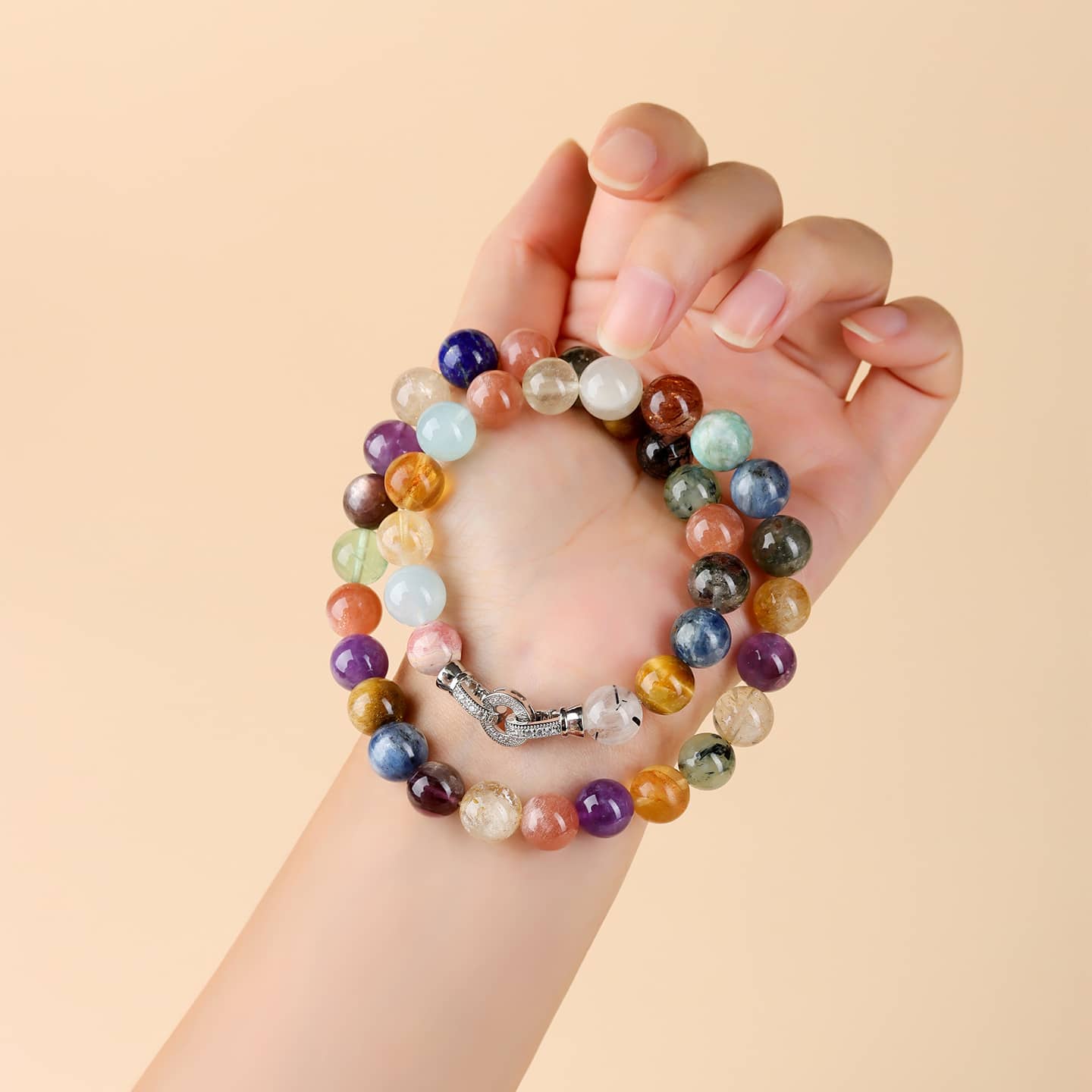 Hand holding an anxiety gemstone necklace featuring colorful stones for calming energy