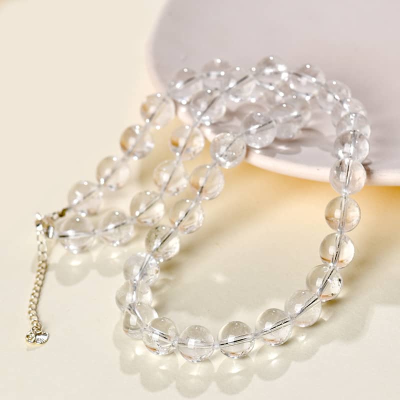 Clear beads of the anxiety soothing crystal necklace on a soft surface, perfect for calming emotions
