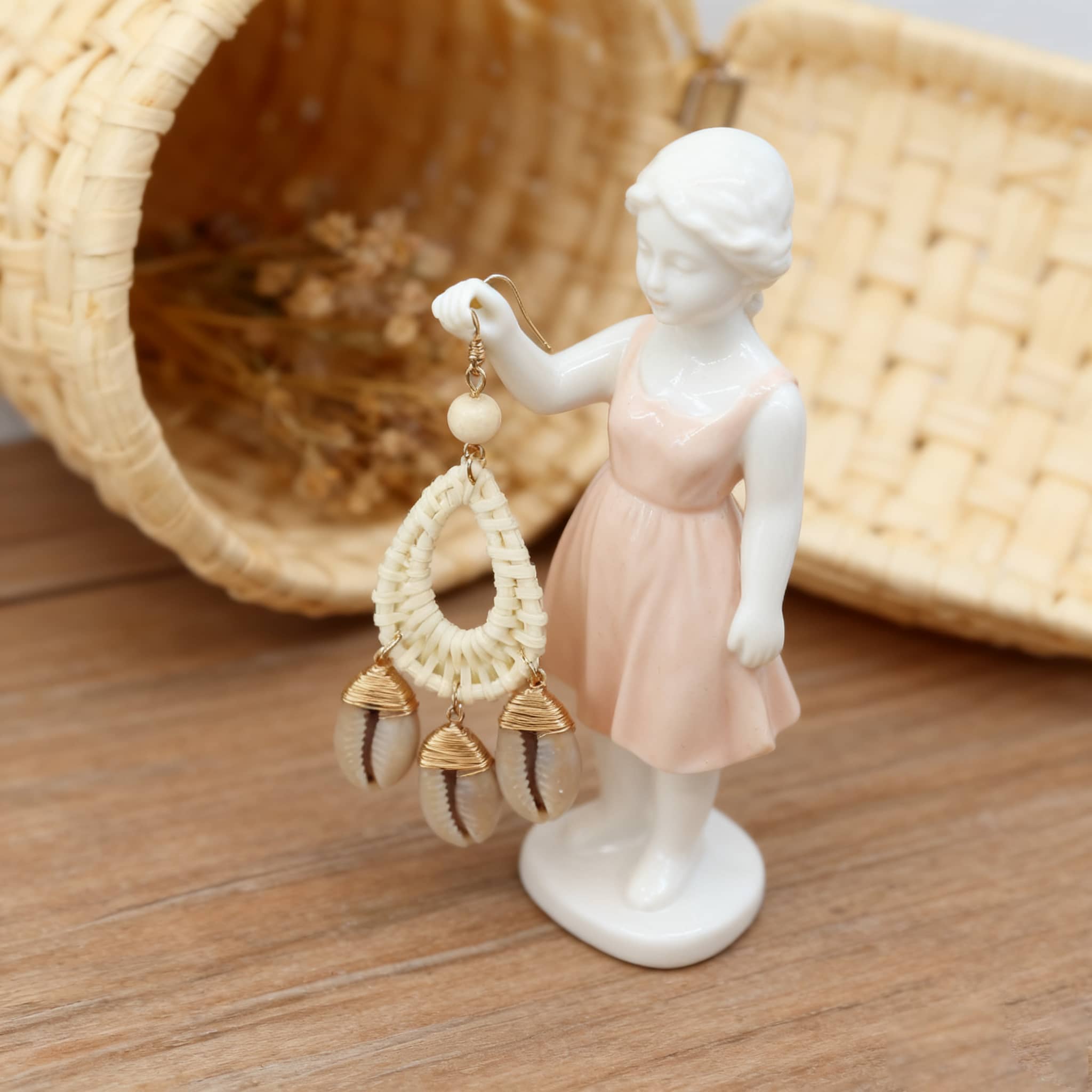 Calm bamboo and seashell drop earrings showcased on a figurine for a stylish look