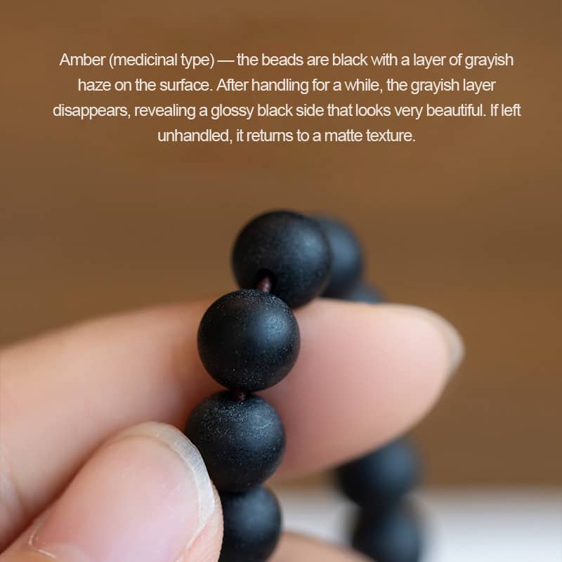 Black amber double wrap bracelet from 5 Senses featuring glossy black beads with grayish haze