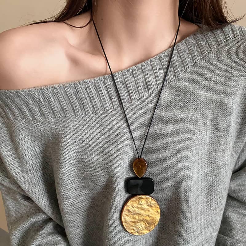 Angry Necklace featuring black and ochre statement jewelry with bold circular pendants