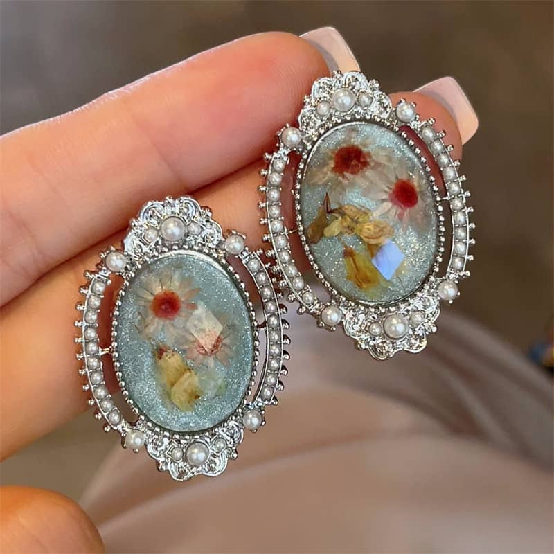 Elegant blue amber earrings for women with floral designs and silver accents