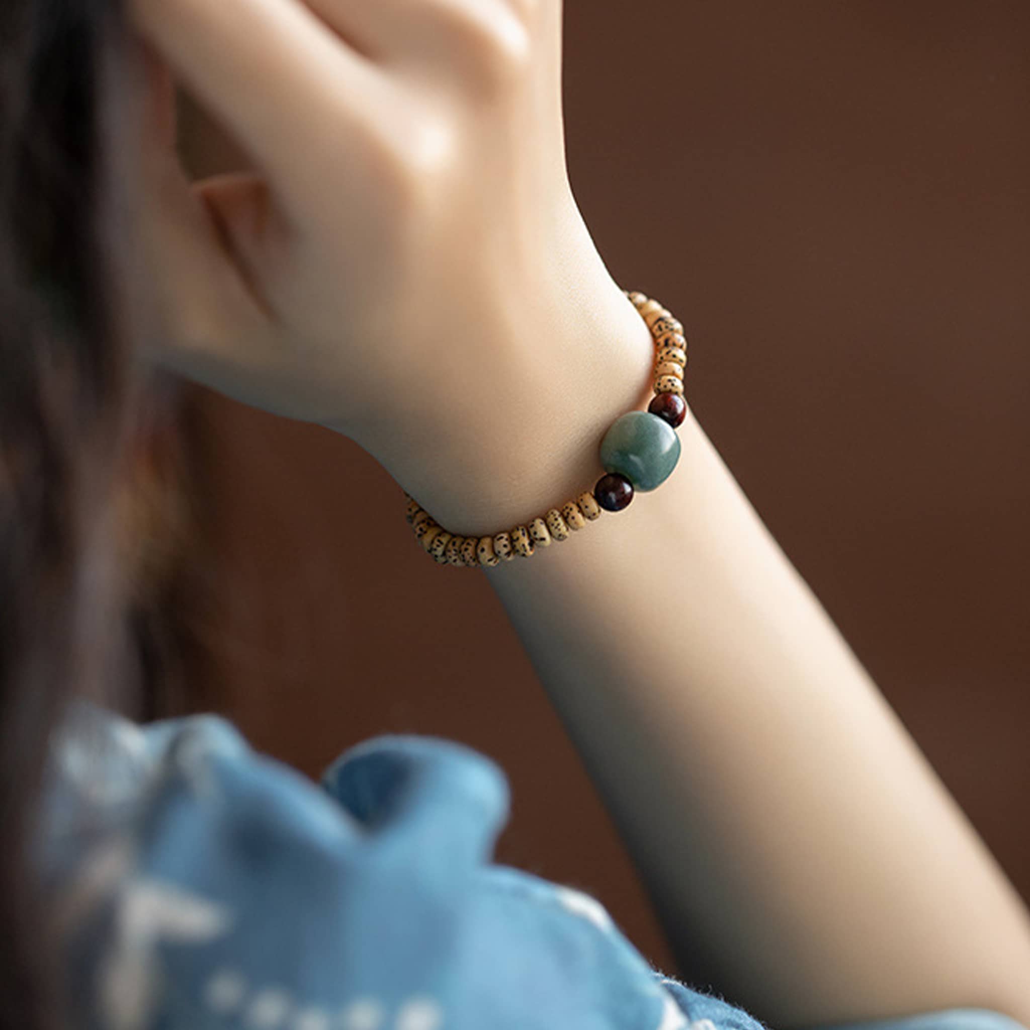 Bodhi seed meditation bracelet featuring natural wood beads and a calming green stone accent