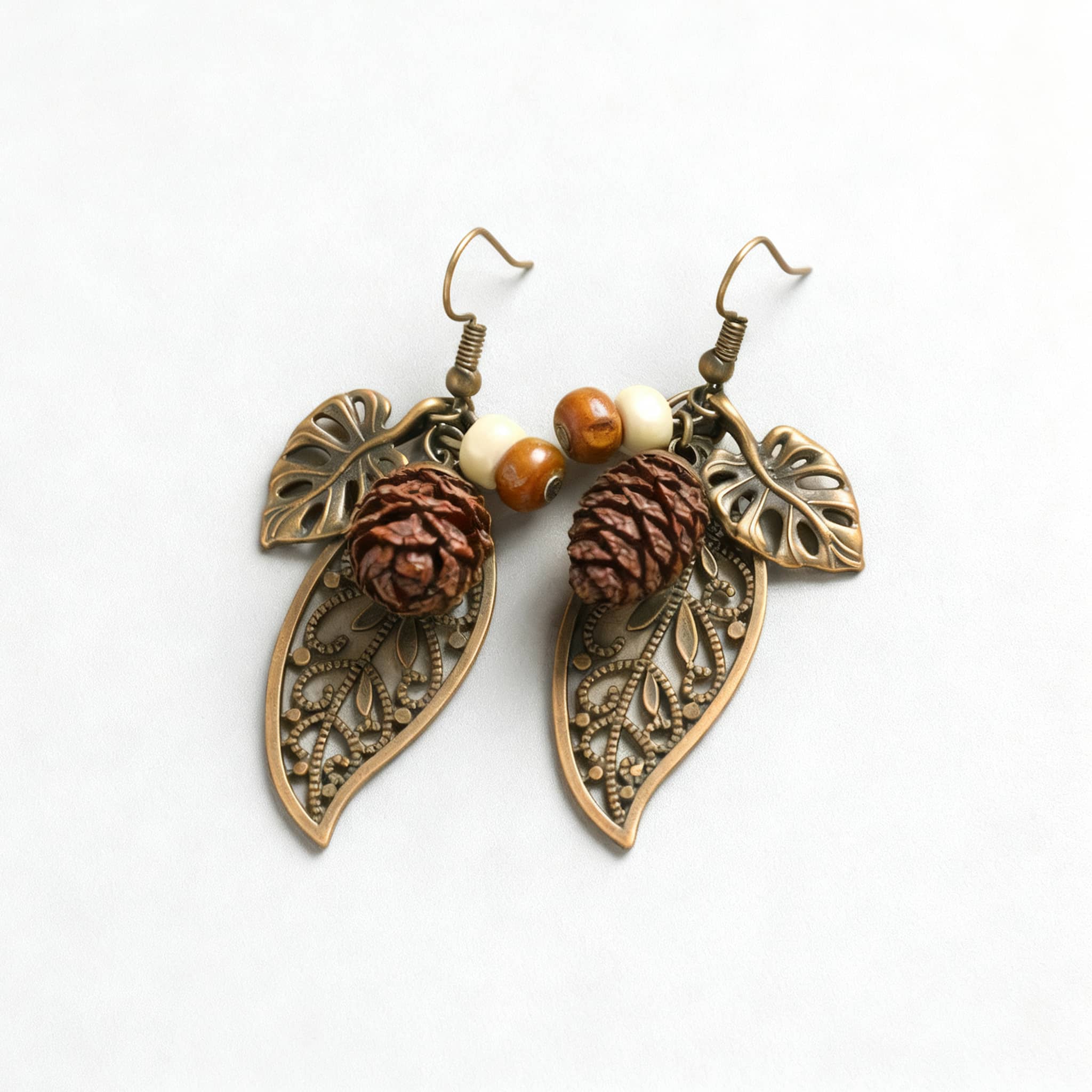 Botanical earrings with pinecone featuring leaf designs and beads for a natural look