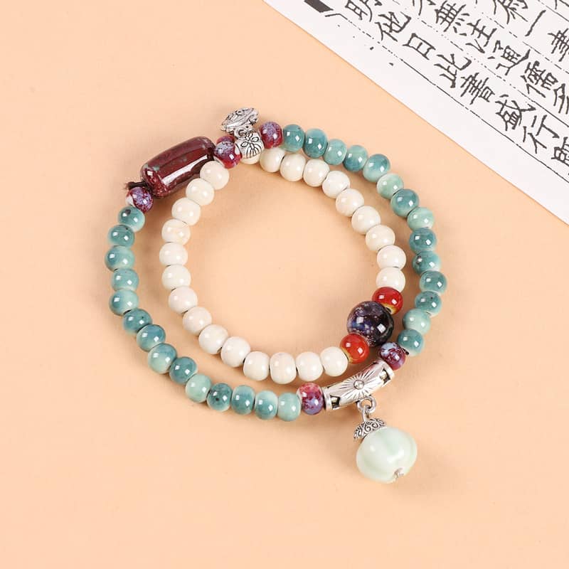 Ceramic bead stacking bracelets in turquoise, white, and purple for a stylish layered look