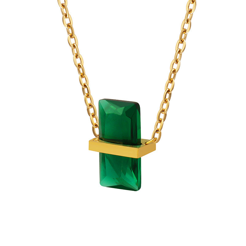 Calm necklace featuring an emerald green pendant necklace with gold chain and rectangular gemstone