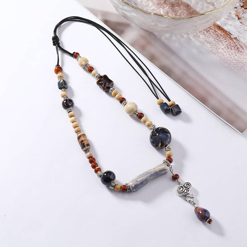 Bohemian necklace featuring a lavender grey ceramic pendant with unique bead accents