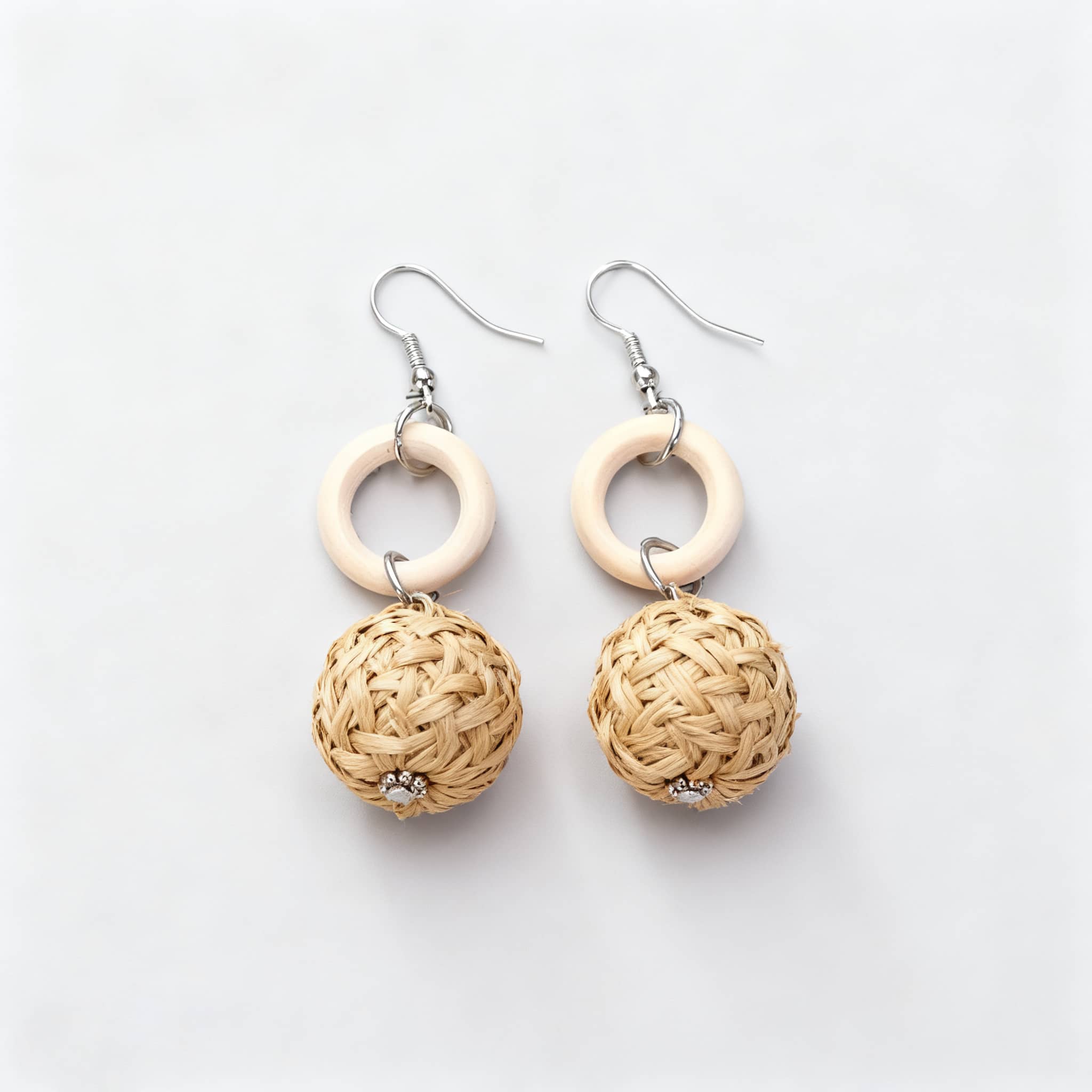 Bamboo woven earrings with natural tones and decorative circular accents for a stylish look