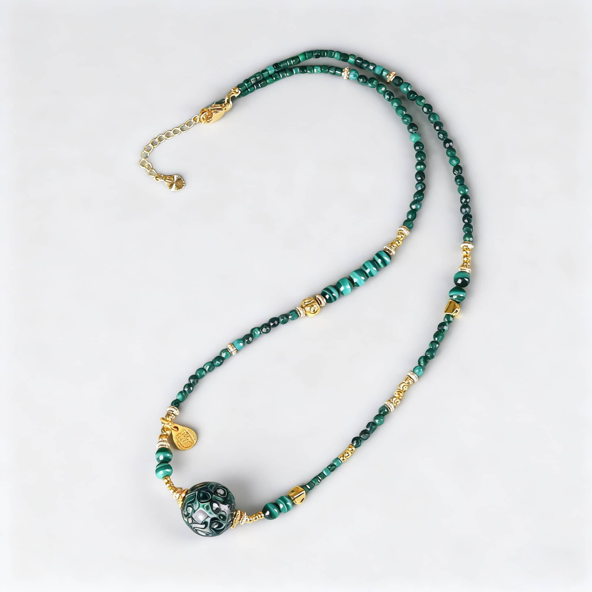 Green urushi mindfulness necklace featuring beads and a decorative pendant for calming energy