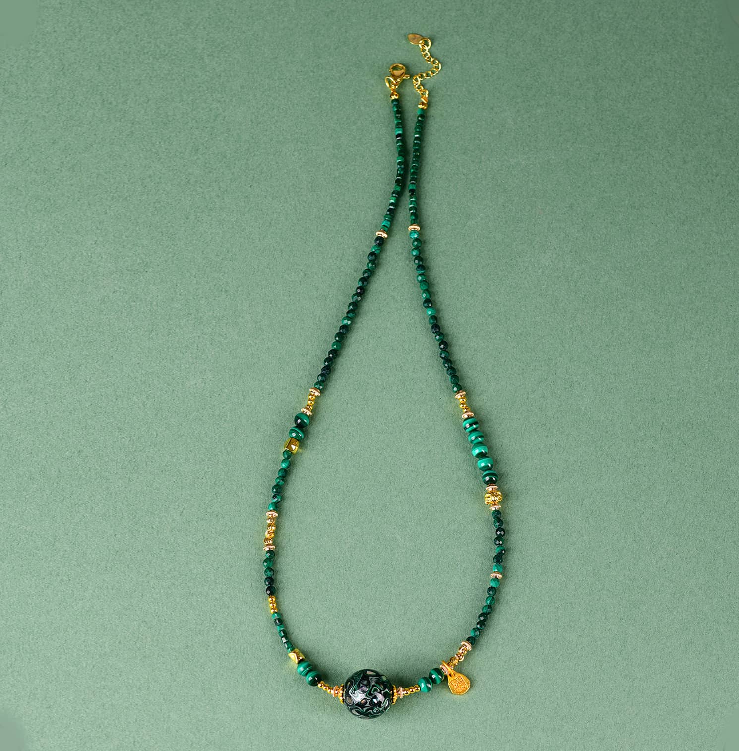 Green urushi mindfulness necklace featuring natural stones and gold accents for a calming aesthetic