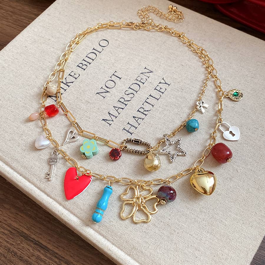 Joy charm locket layered necklace featuring colorful charms and gold chain for a playful accessory