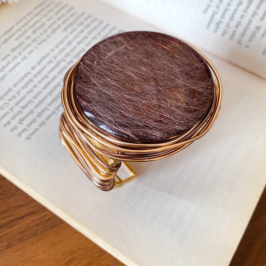Handcrafted mindful resin cuff bracelet with a unique dark brown stone and gold wire design