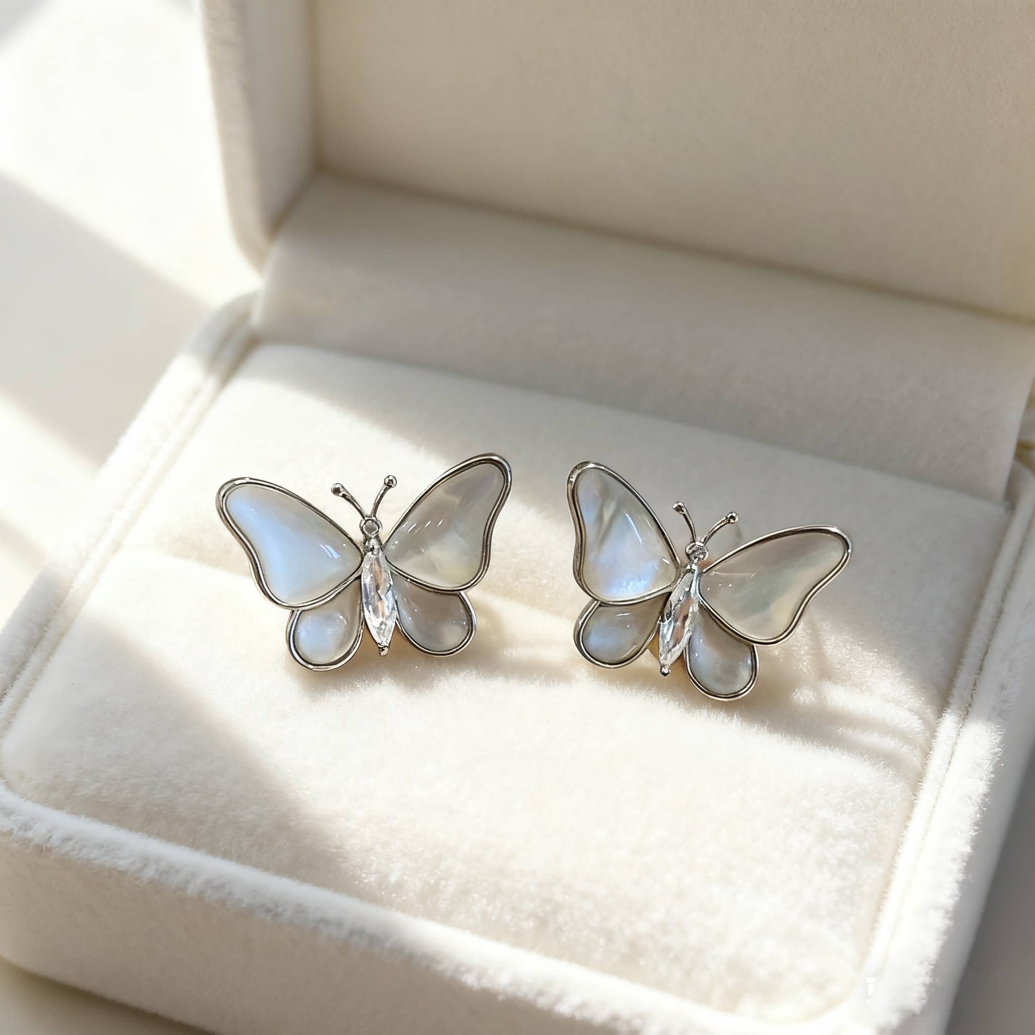 Elegant mother of pearl butterfly earrings with sparkling accents for a stylish look