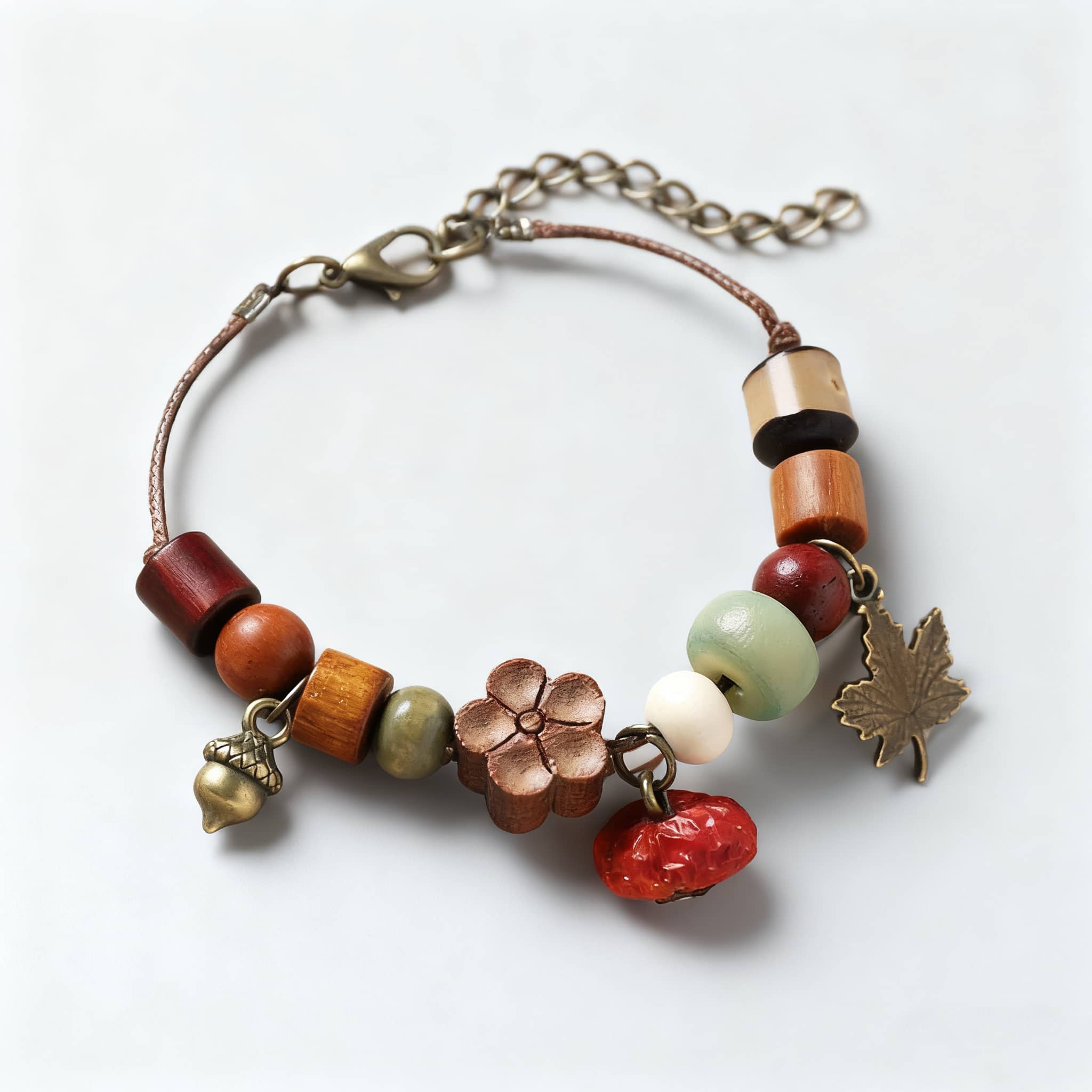 Red berry wood bead bracelet with colorful wooden beads and charming leaf charm detail