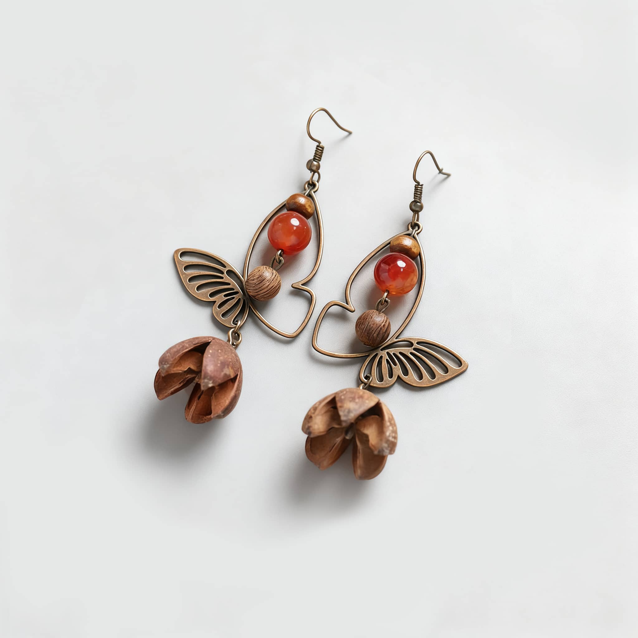 Vintage butterfly earrings featuring intricate metalwork and natural wooden accents