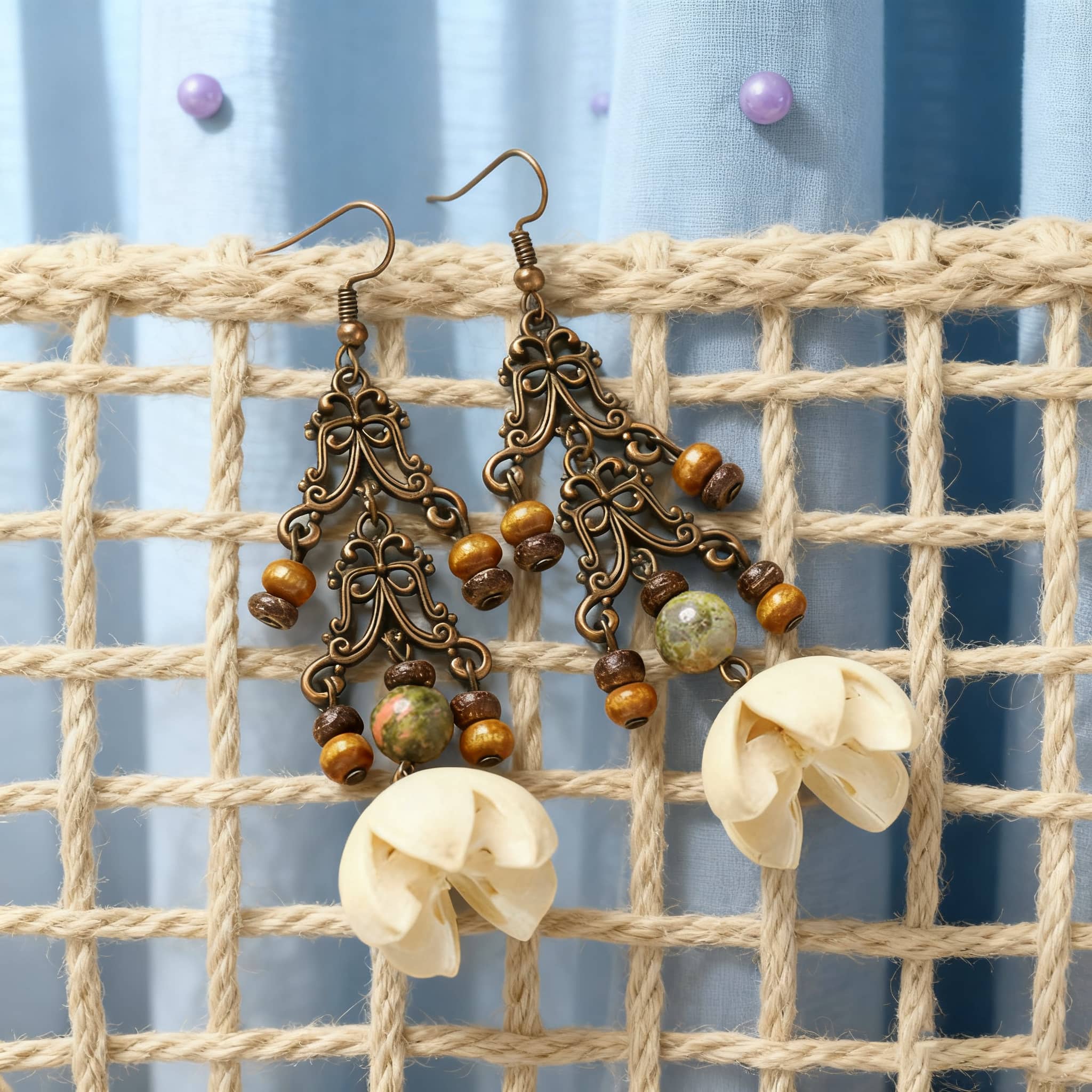 Vintage cut-out metal earrings with decorative beads and floral design for a unique statement look
