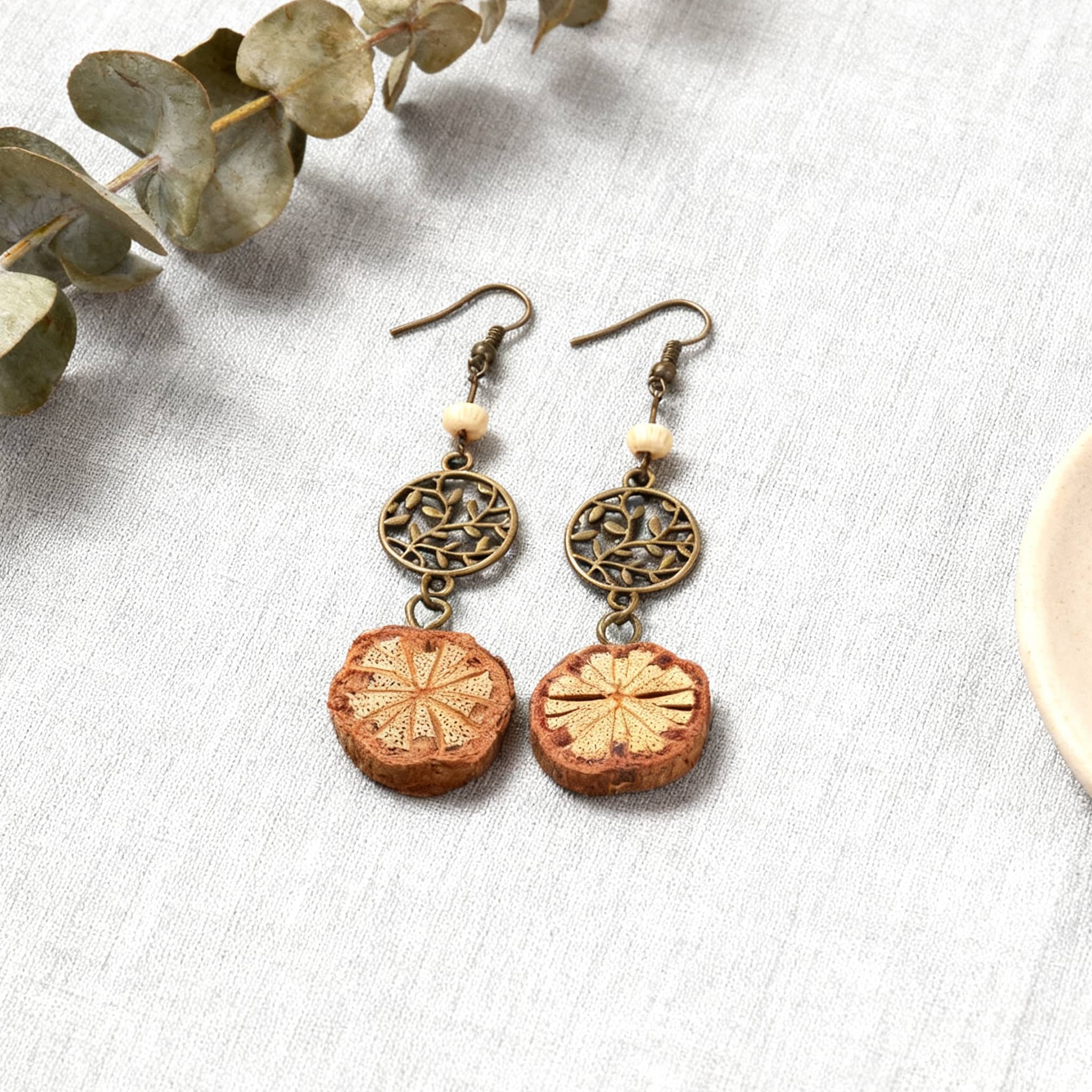 Vintage vine earrings featuring intricate metal designs and natural wood accents for a boho look