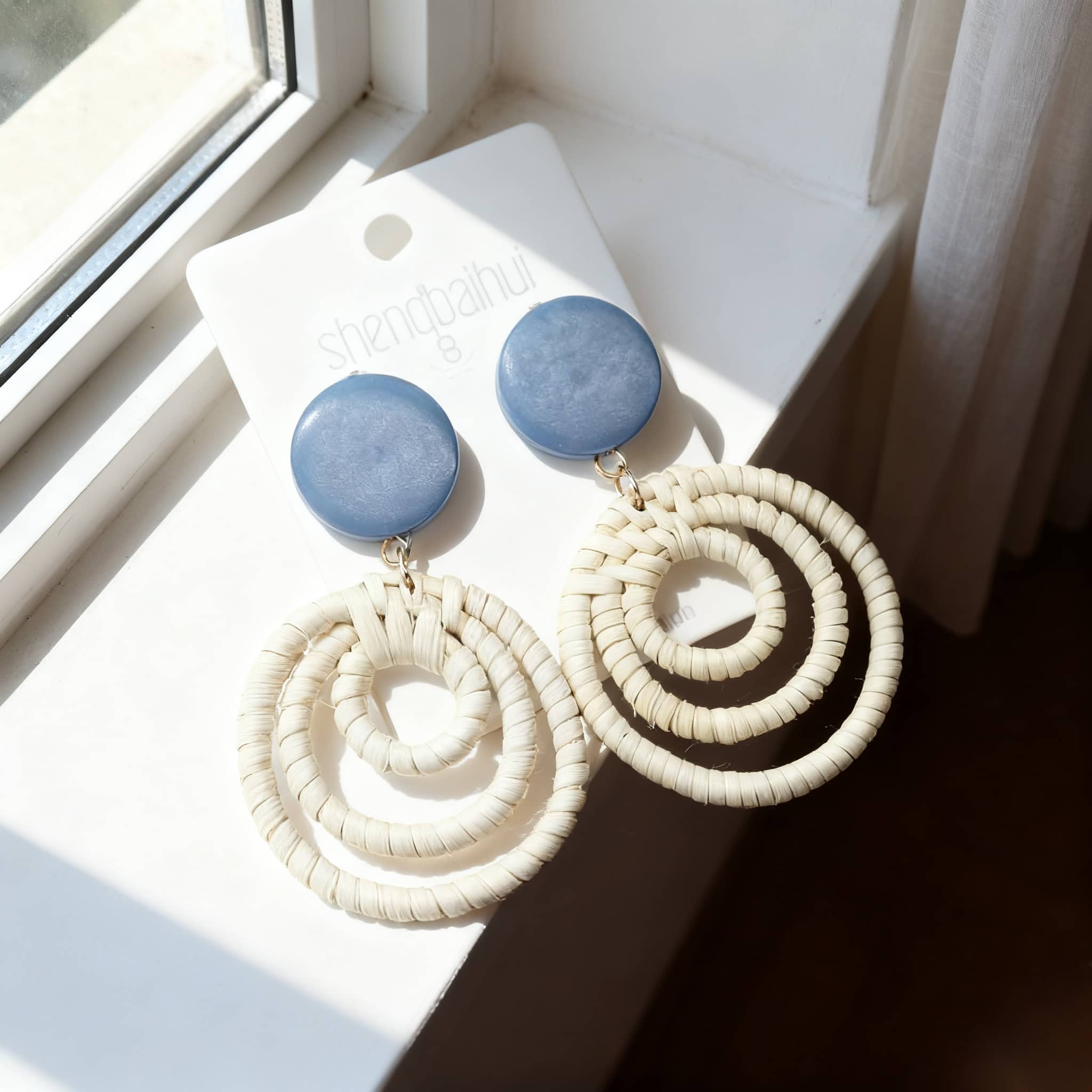 Woven bamboo statement earrings with cream loops and blue top stones from 5 Senses