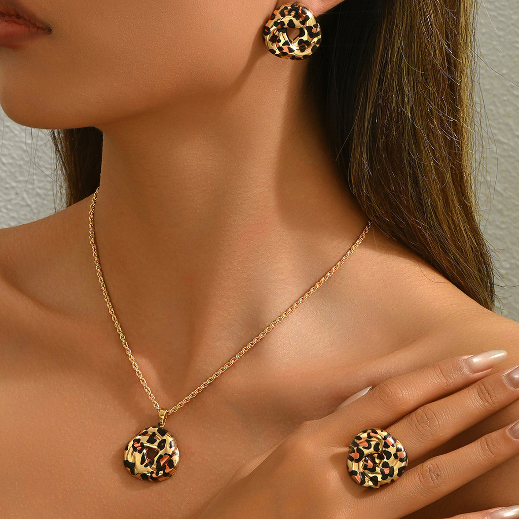 Model wearing geometric leopard jewelry set gold chain necklace matching leopard print earrings and ring