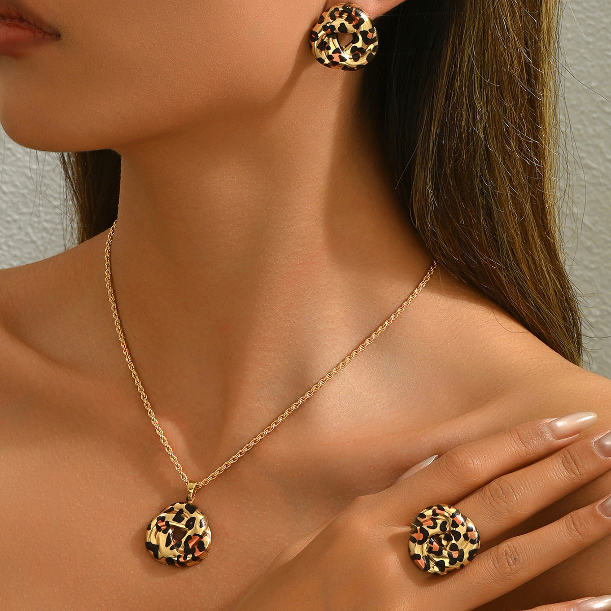 Model wearing geometric leopard jewelry set gold chain necklace matching leopard print earrings and ring