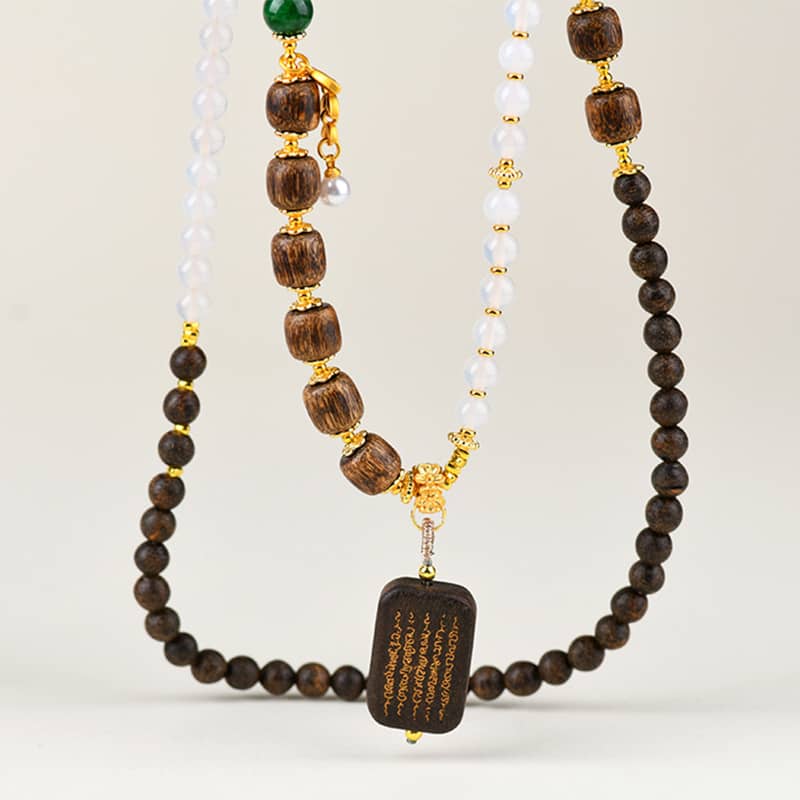 Anxious Necklace featuring agarwood and white onyx jewelry with unique bead design