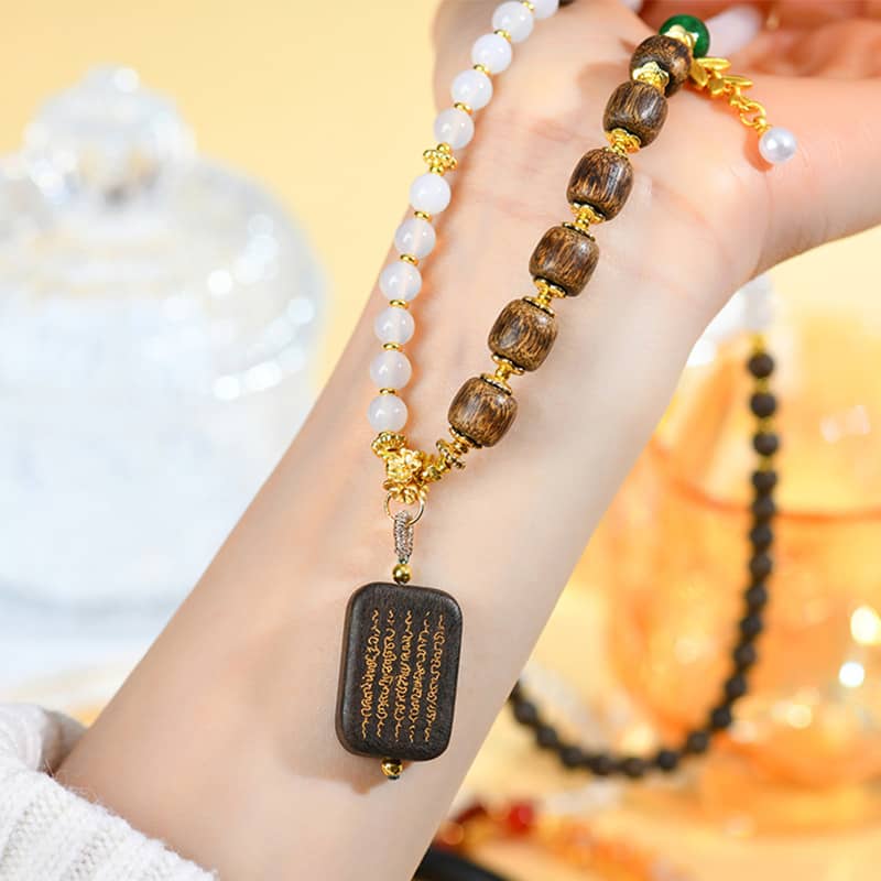 Anxiety relief necklace featuring agarwood and white onyx jewelry with gold accents and beautiful beads