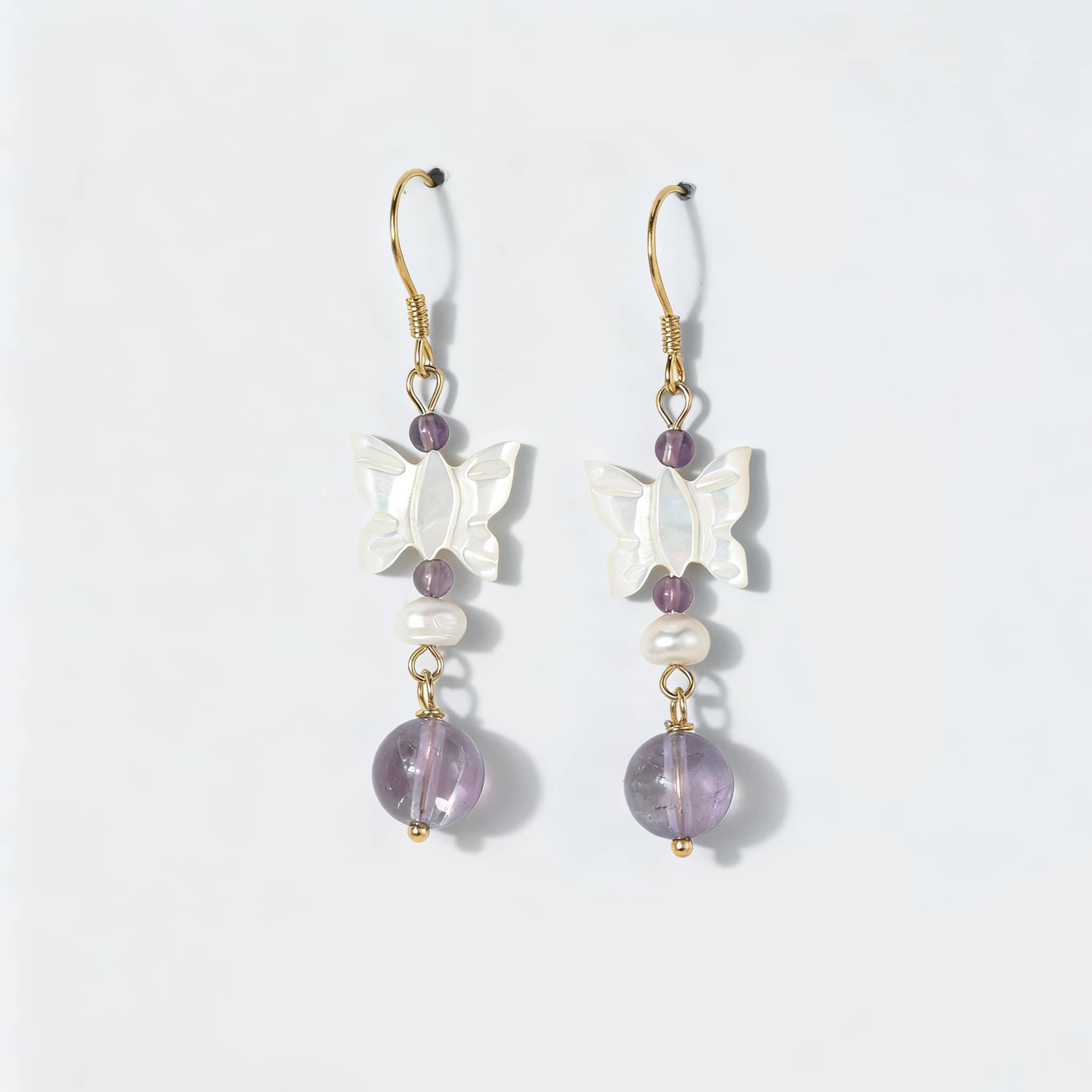 Amethyst butterfly pearl earrings featuring a delicate butterfly design and sparkling amethyst beads