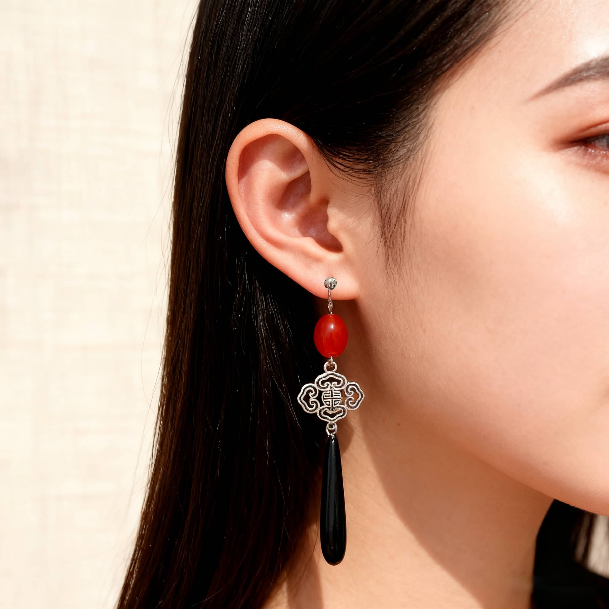 Stylish anger teardrop earrings featuring red beads and elegant design, perfect for bold fashion statements
