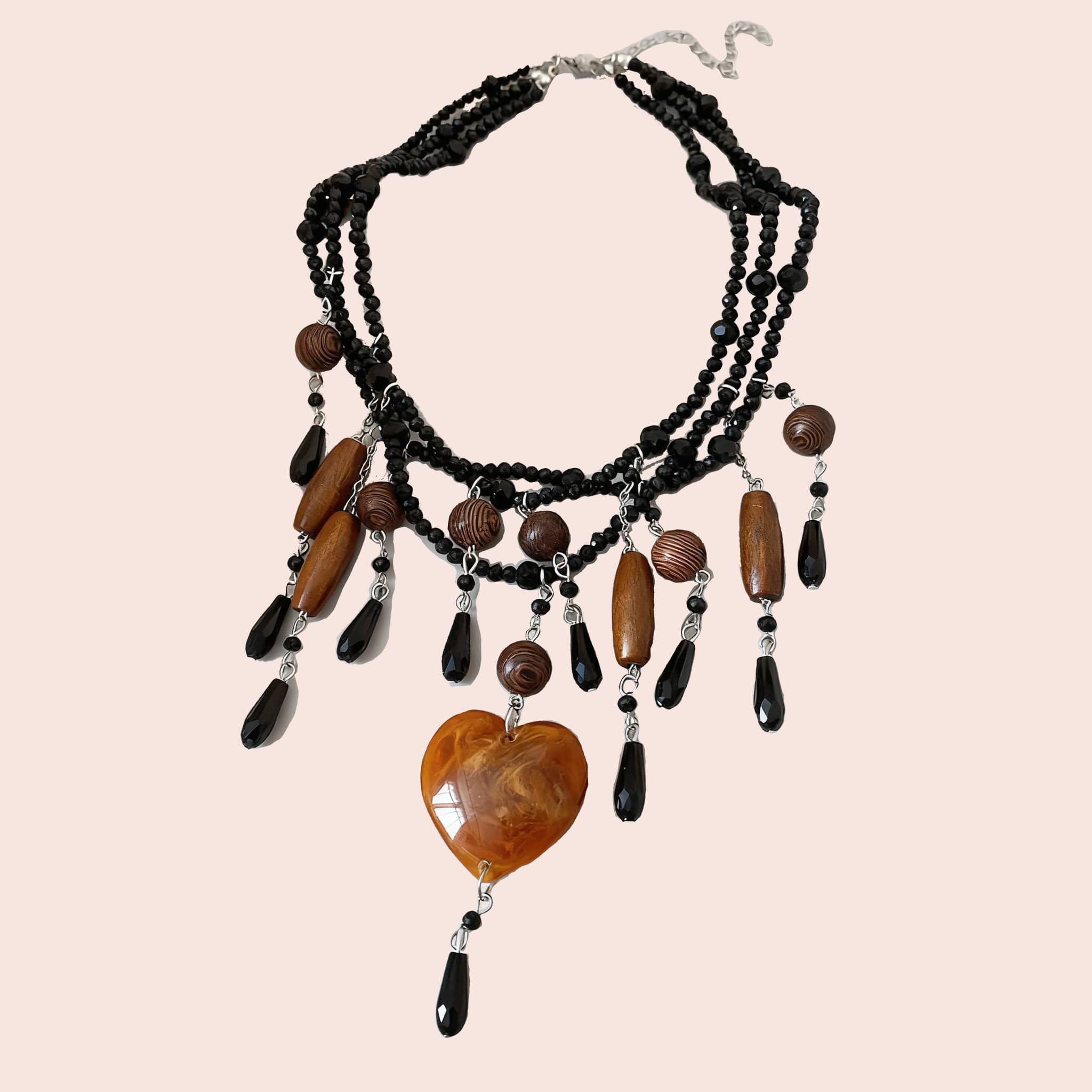 Angry heart resin necklace with black beads and brown accents for a unique statement look