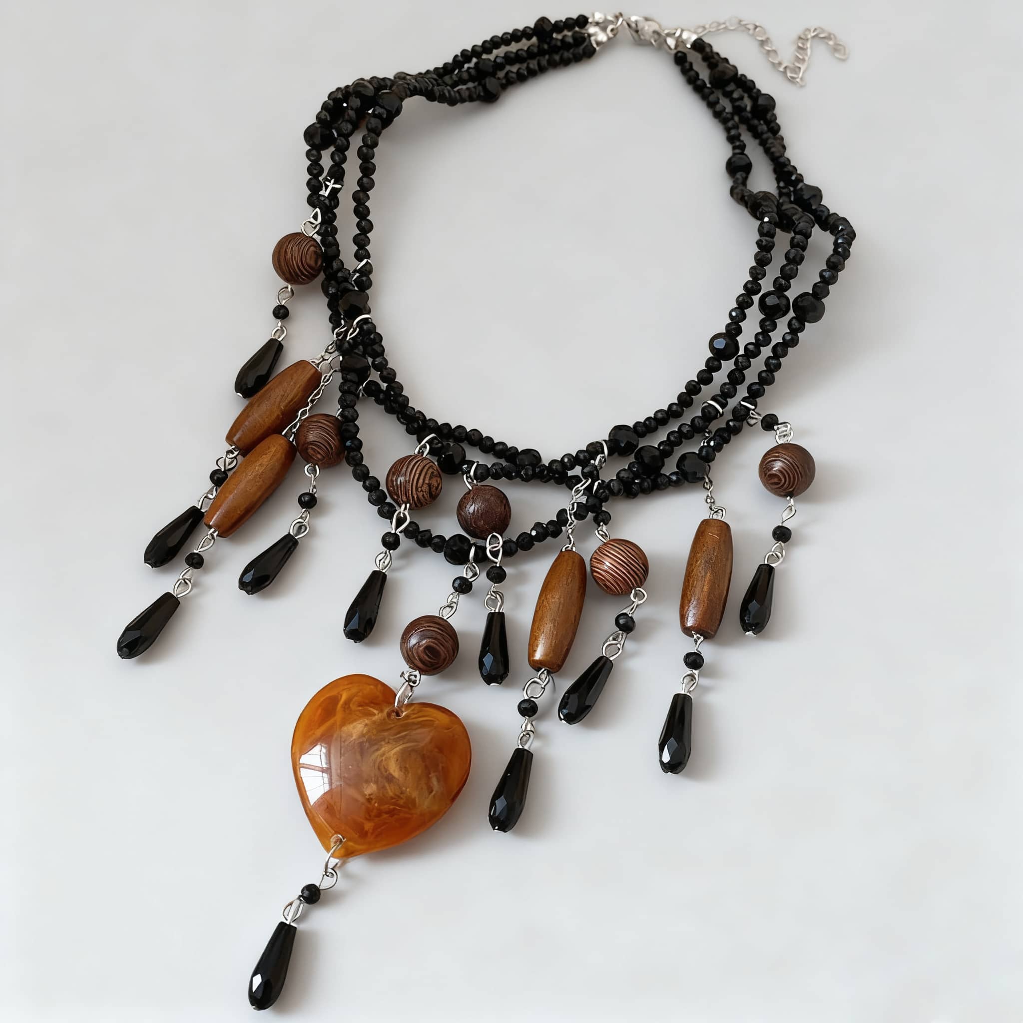 Angry heart resin necklace with black beads and decorative pendants for a bold fashion statement
