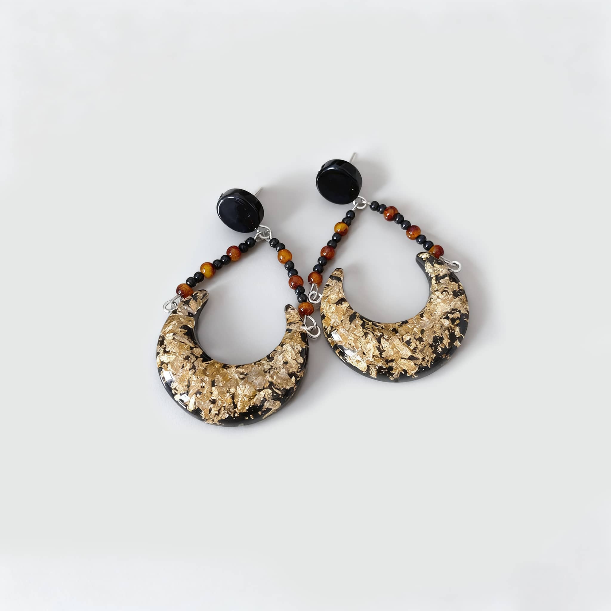 Unique angry resin moon earrings with gold detail and bead accents for a stylish look