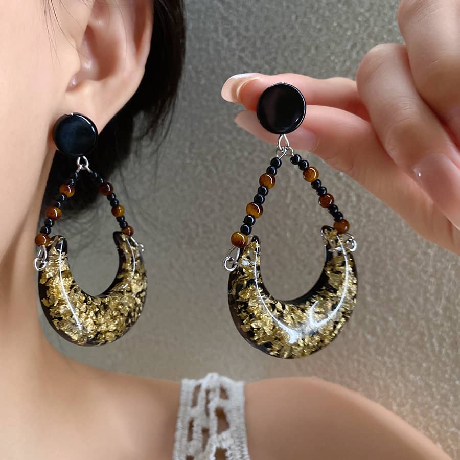 Angry resin moon earrings featuring glitter and beads for a unique statement look