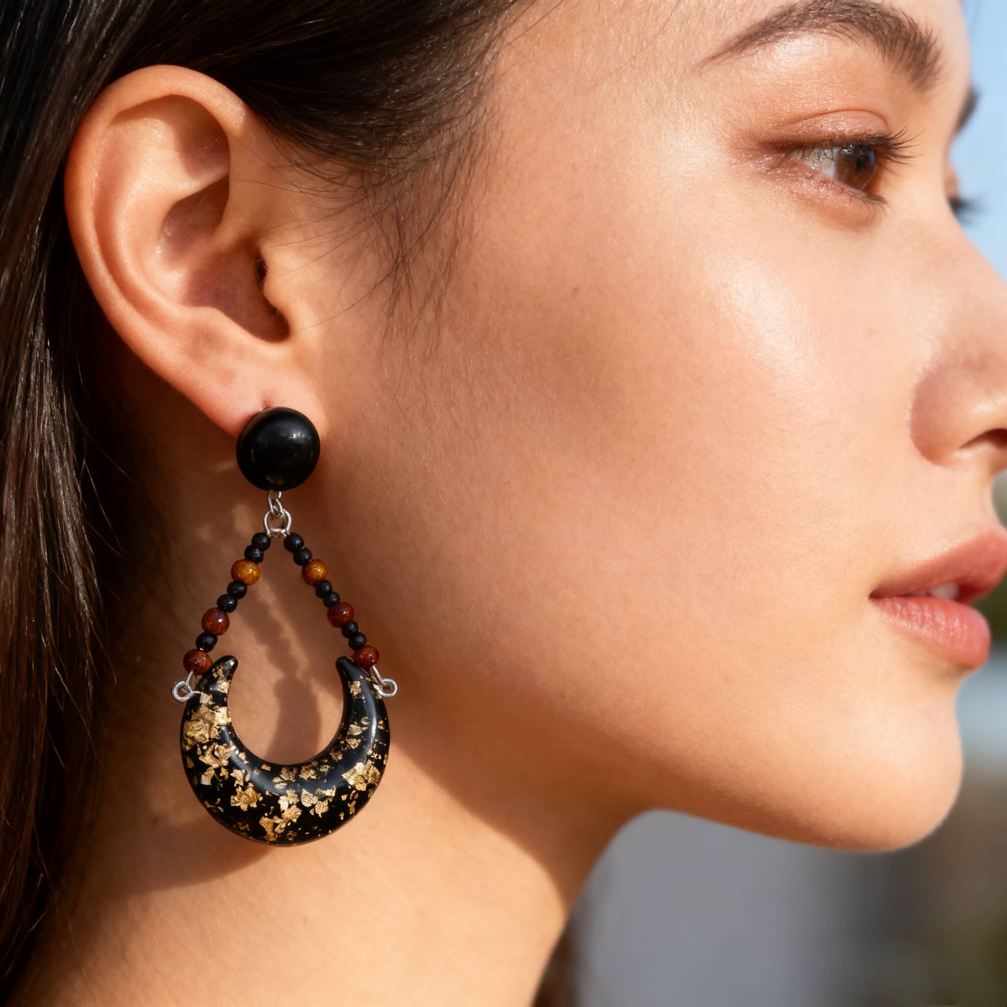 Angry resin moon earrings with black and gold accents for a bold fashion statement
