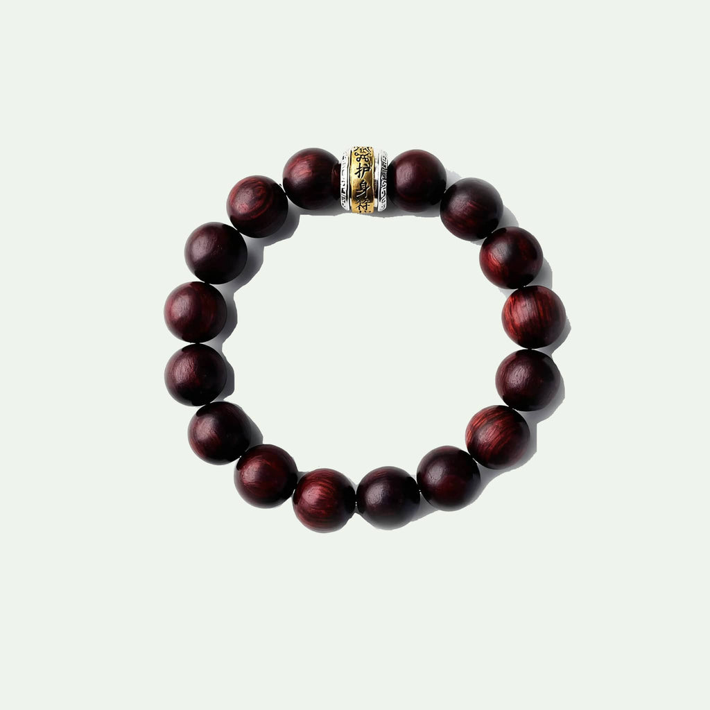 Antique rosewood mala bracelet featuring polished beads and decorative gold spacer for mindfulness practice