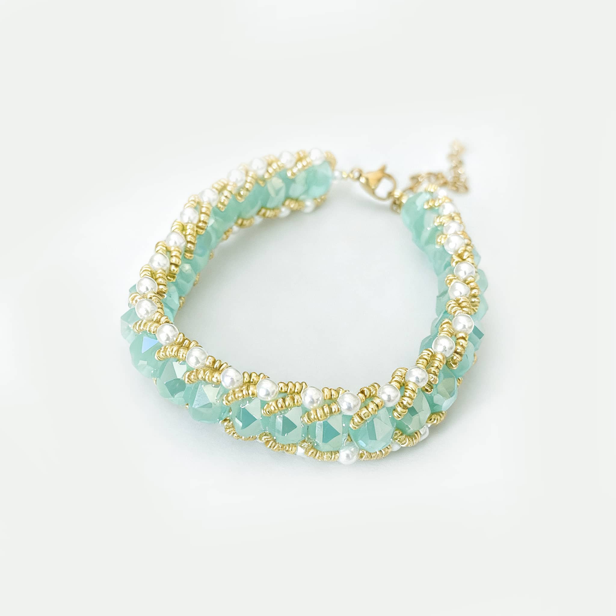 Elegant aqua glass and pearl bracelet with gold accents, perfect for any occasion