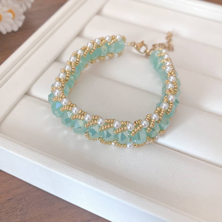 Aqua glass and pearl bracelet with gold accents, perfect for adding elegance to any outfit
