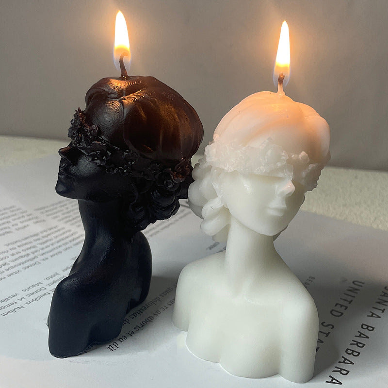 Black and white bust candles burning showcasing aromatherapy art candle gift with detailed facial features