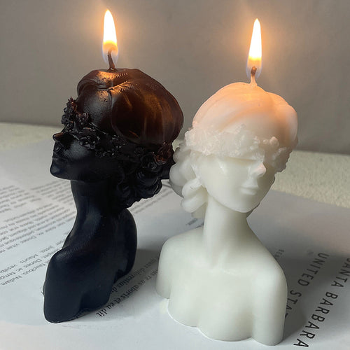 Black and white bust candles burning showcasing aromatherapy art candle gift with detailed facial features