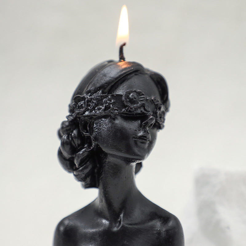 Black sculpted aromatherapy art candle gift shaped like a blindfolded woman with floral headband