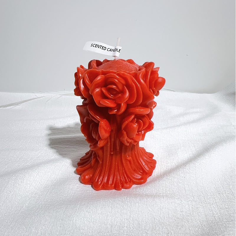 Red aromatherapy rose candle with detailed rose patterns and scented candle label