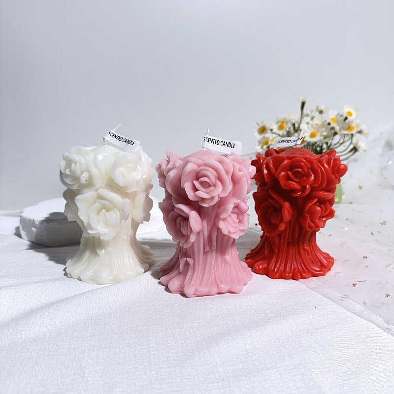 Set of white pink and red aromatherapy rose candle with detailed floral design on white fabric