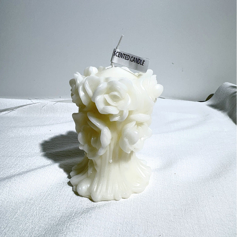 White aromatherapy rose candle with detailed rose shapes and scented label on top