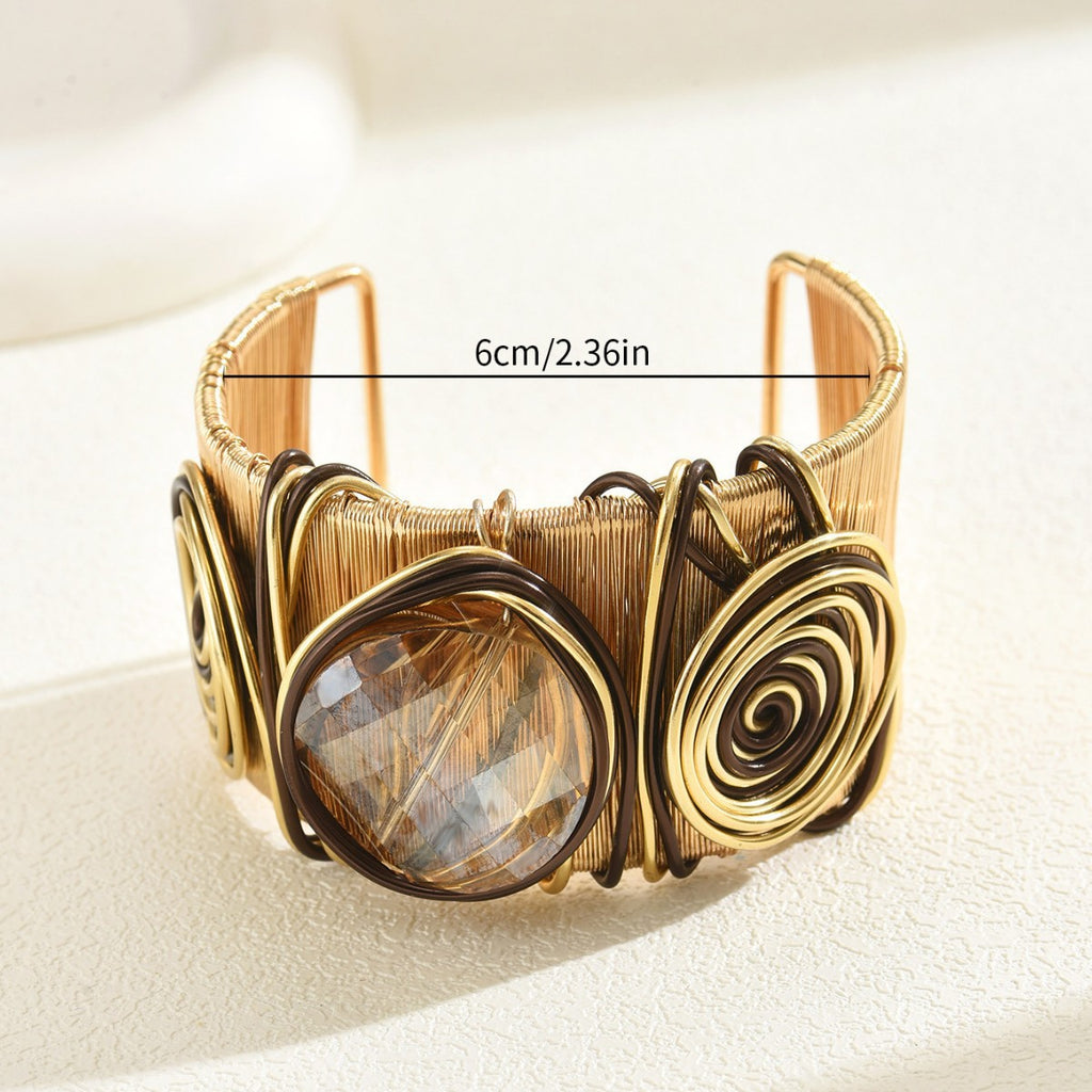 Gold wire wrapped bold gemstone cuff bracelet with faceted central stone and spiral wire accents 6cm width