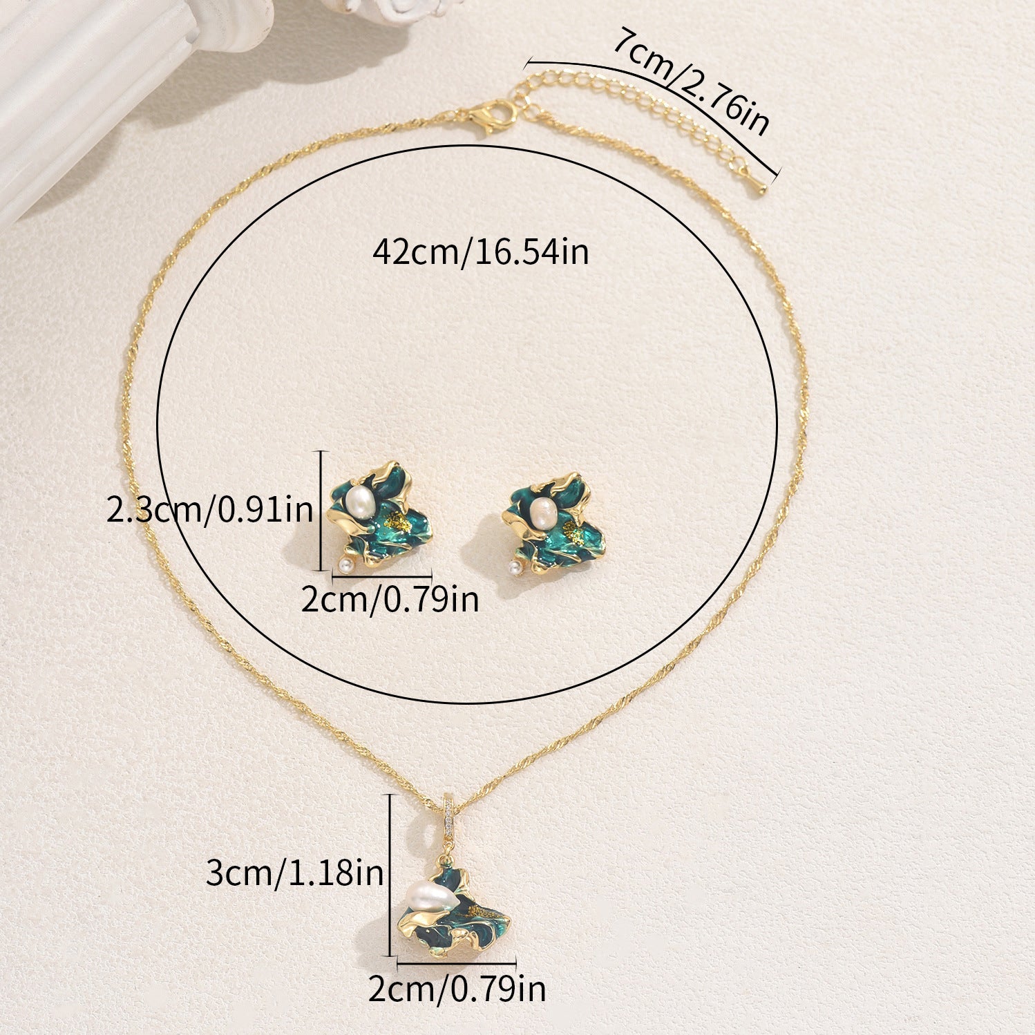 Gold chain necklace with leaf green enamel pendant and matching stud earrings featuring pearls in a lake shaped pearl jewelry set
