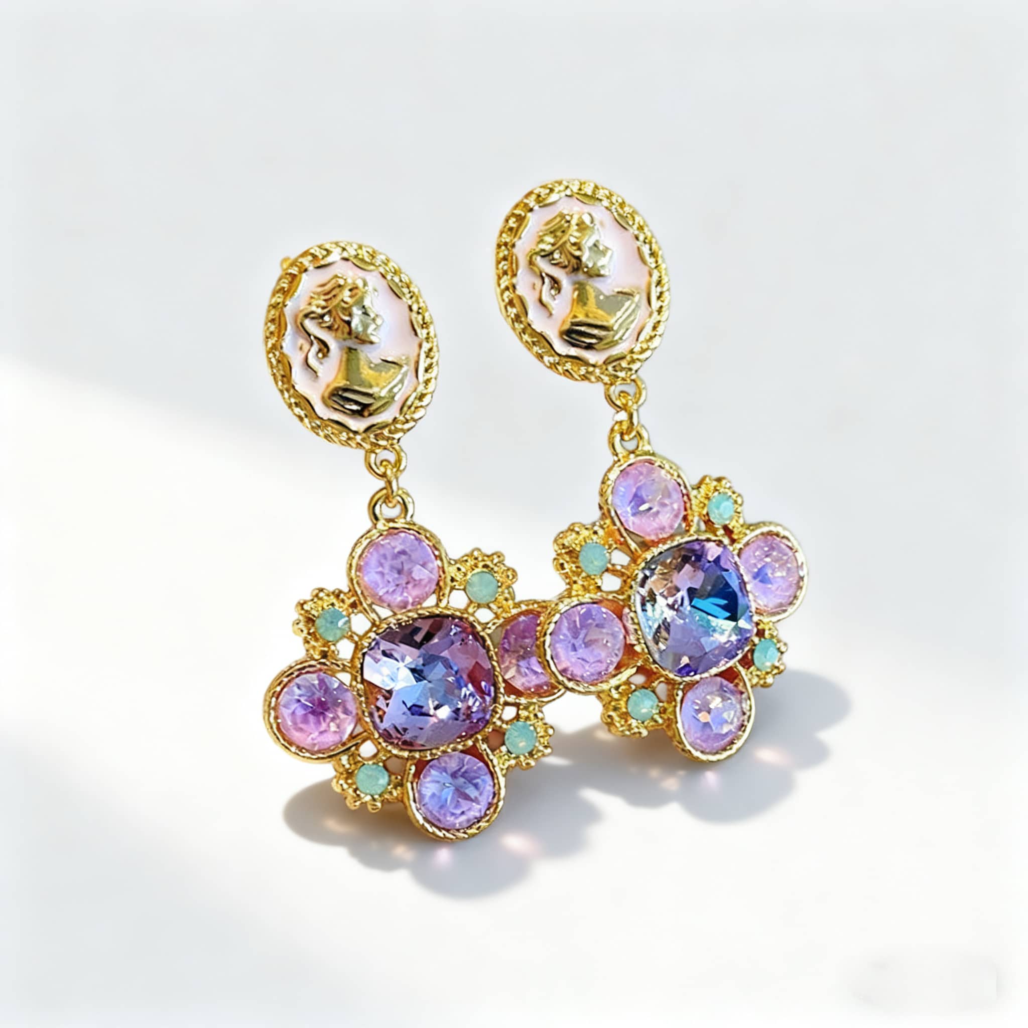 5 Senses baroque cameo floral earrings featuring butterfly designs in a vintage tin box