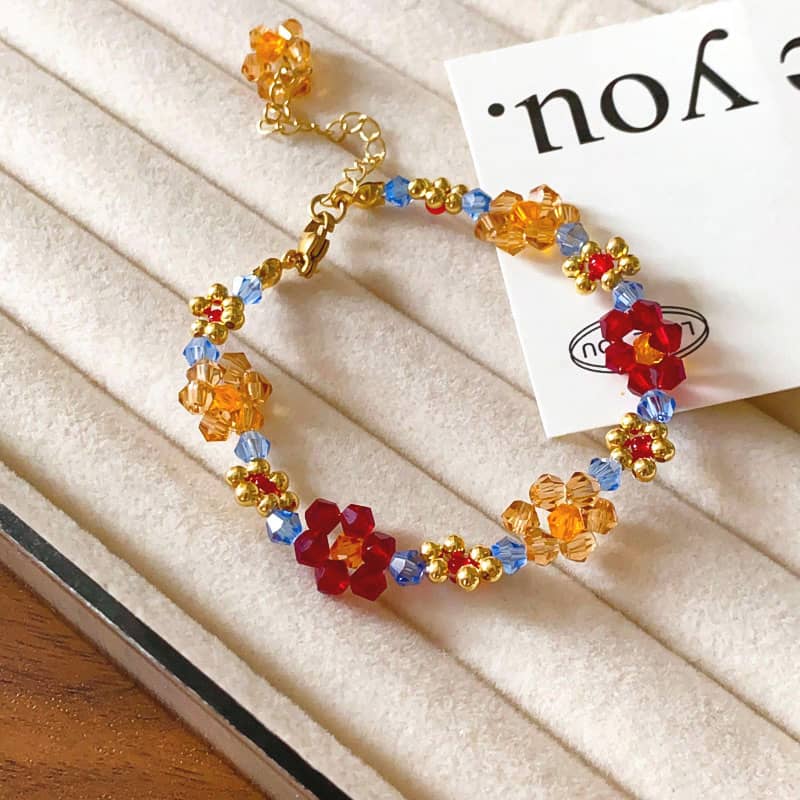 Colorful beaded flower bracelet featuring gold accents and vibrant flower designs