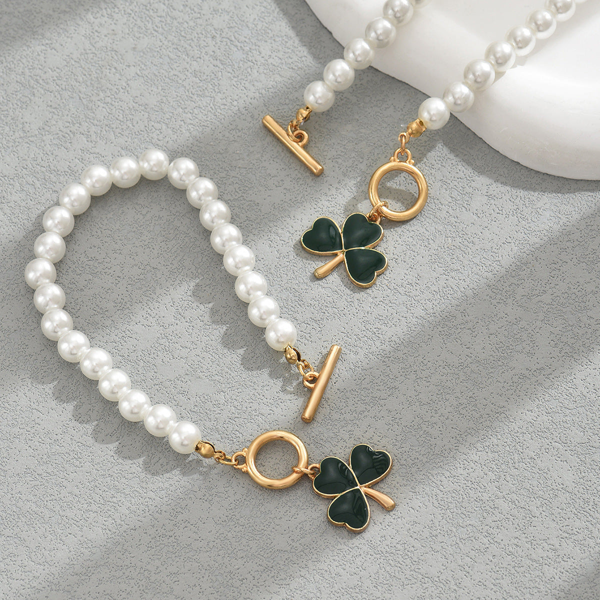 heart and clover pearl jewelry set with gold toggle clasps and green enamel four leaf clover charms on pearl bracelets